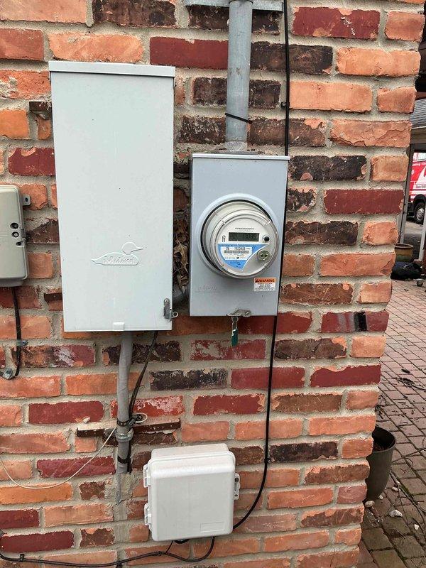 Completed full HVAC system installation including a 110,000 BTU gas furnace with right-side configuration and 4-ton air conditioning unit in residential mechanical room. Installed Aprilaire humidifier mounted on furnace, new thermostat, and 20x25x1 filter base with 600 CFM airflow capacity. Ran new PVC venting and drainage lines, connected copper refrigerant lines, and installed metallic ductwork with proper segmented joints. Mounted exterior electrical disconnect and established utility meter connections on exterior brick wall. Reconnected all necessary gas, electrical, and plumbing connections. Obtained mechanical and electrical permits and remeasured return air for proper system sizing. System qualified for utility rebate program and passed all code inspections.