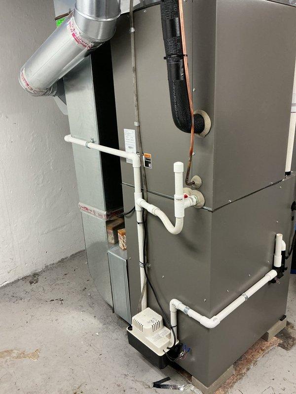 Completed comprehensive Gold-level furnace inspection on a 2-year-old forced air heating system located in the basement. Performed thorough visual examination of all accessible components including heat exchanger, burner assembly, blower motor, and electrical connections. Inspected condensate pump and drainage system, verified proper operation of all safety controls, and examined ductwork connections. Documented equipment condition through photographic records showing internal components and overall system installation. All components found operating within normal parameters with no immediate service needs identified.