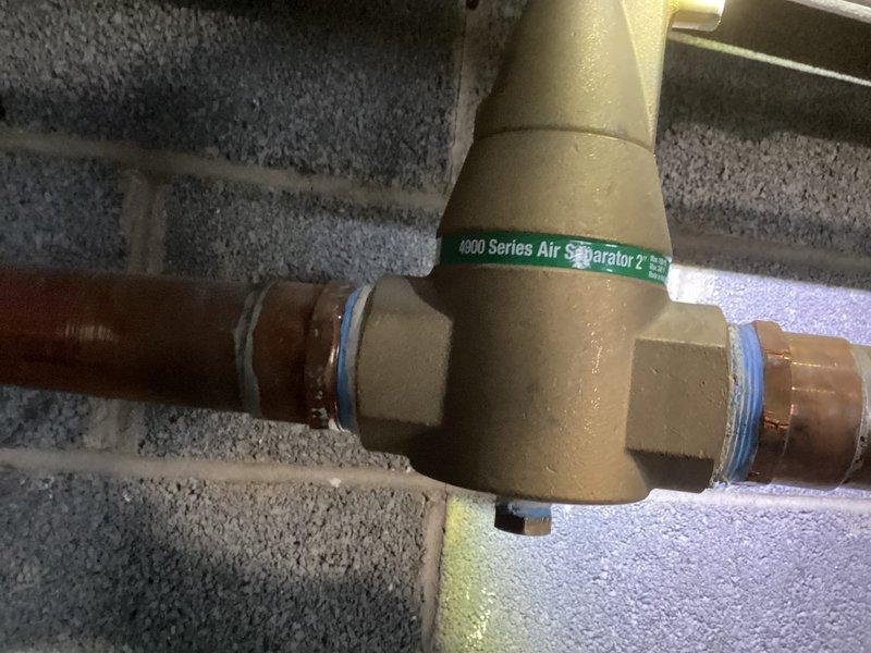 Responded to service call for commercial furnace system located in basement mechanical room. Upon arrival, inspected 10+ year old heating system and associated hydronic components including 4900 Series Air Separator and connected copper piping. Performed diagnostic evaluation of furnace operation, examined air handler unit, verified proper function of water heater and flue connections, and assessed condition of manifold system and related plumbing components. All equipment photographed and documented for service records.