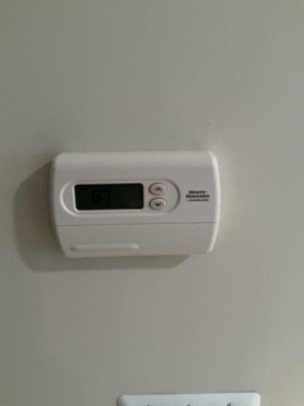 Responded to lower level heating complaint where thermostat was set to 71 degrees but temperature would not rise above 65-67 degrees. Evaluated 3-4 year old furnace system located in basement with White-Rodgers thermostat and humidifier attachment. Diagnosed failed secondary heat exchanger and tripped rollout limit switch on the unit. Provided estimate for complete furnace replacement and optional air conditioning system upgrade due to age and condition of existing equipment requiring major component replacement.