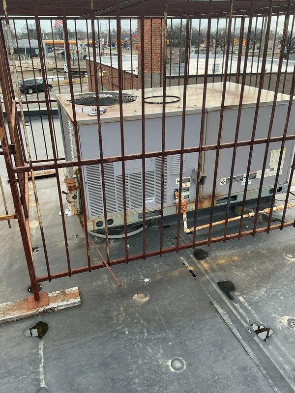 Responded to service call for commercial rooftop furnace with broken belt. Accessed roof using ladder and located unit among multiple HVAC systems on flat membrane roof. Removed failed belt and installed replacement belt, ensuring proper tension and alignment. Tested unit operation to verify proper function and airflow. Unit restored to full operational status.