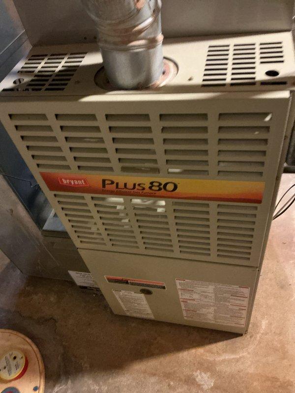 Responded to no-ignition complaint on basement-located furnace over 10 years old. Performed diagnostic evaluation and identified cracked heat exchanger, rendering unit unsafe for operation. Provided comprehensive replacement estimate for new HVAC system including furnace and associated components, documented existing Bryant Plus 80 equipment configuration with photos showing current installation layout, ductwork connections, and venting system for replacement planning purposes.
