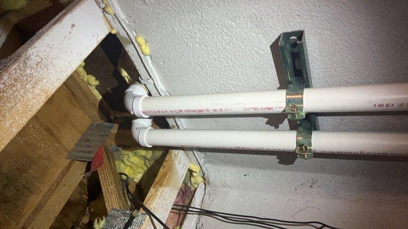 Responded to service call for sprinkler system supply line requiring repair. The issue involved a water supply pipe running through the interior of the residence to the exterior sprinkler system connection point. Upon inspection, identified deteriorated plumbing components in the utility area, including corroded piping connections and compromised fittings near water distribution equipment. Performed diagnostic assessment of the water supply routing from interior mechanical space through structural framing to exterior hose bib connection. Documented existing conditions showing significant corrosion on mechanical equipment and aging PVC supply lines with multiple connection points. Repaired the affected pipe section serving the sprinkler system, ensuring proper water flow restoration and eliminating the leak condition at the faucet connection point.