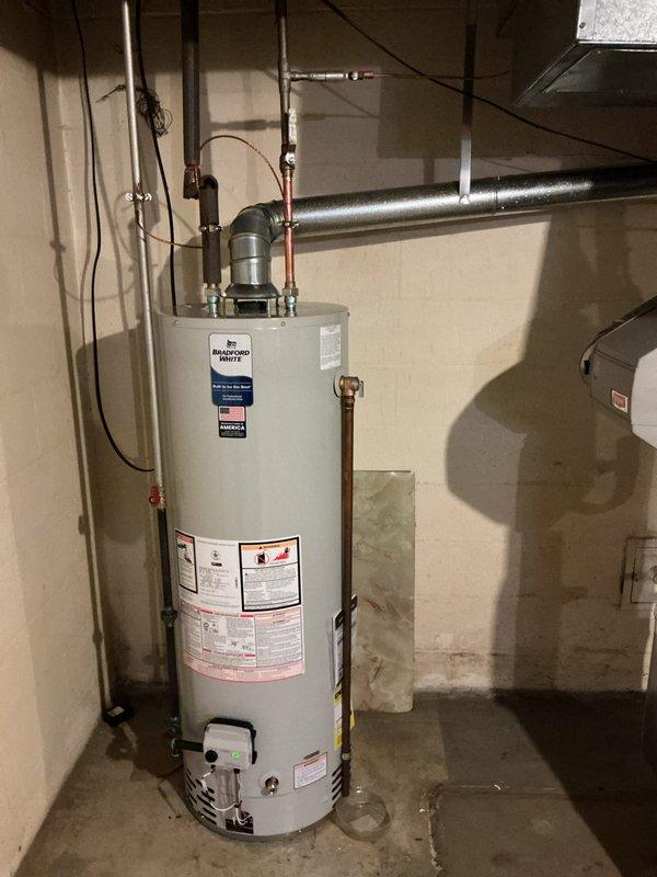 Installed a 40-gallon Bradford White tanked water heater in basement utility room, completing all copper piping connections for inlet and outlet lines with appropriate valves and fittings. Permit was requested for the installation, and the unit was properly secured and vented according to manufacturer specifications and local code requirements.