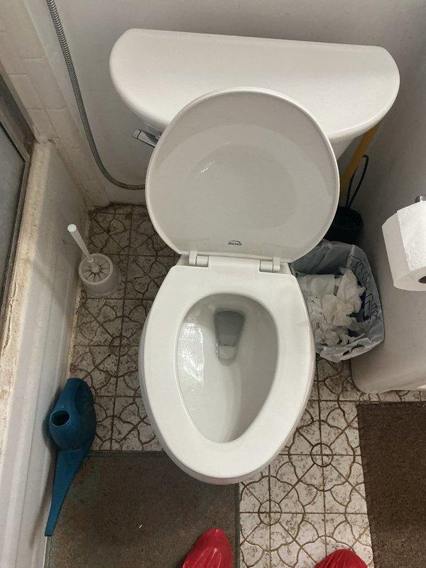 Responded to service call for toilet leak in master bedroom causing water damage to basement below. Upon inspection, identified failed wax ring seal at toilet flange connection allowing wastewater to seep through floor assembly into lower level. Examined basement ceiling plumbing assembly and confirmed active leak originating from toilet drain connection. Observed corroded brass closet flange fittings and aged metal drain components contributing to seal failure. Removed toilet from floor, scraped old wax ring residue from flange and toilet horn, and inspected flange for structural integrity. Replaced wax ring with new reinforced seal and reinstalled toilet with proper alignment and secure bolting to flange. Reconnected water supply line and tested flush cycles for proper drainage and seal integrity. Verified no leakage at base during multiple flush tests. Inspected basement area beneath repair location and confirmed cessation of active leak. Advised homeowner regarding previously noted