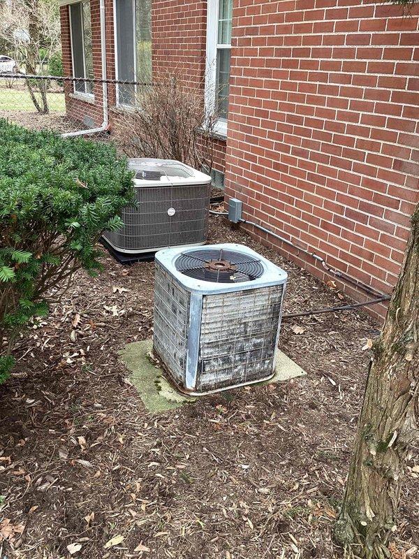 Conducted comprehensive site assessment for complete HVAC system replacement at residential property. Evaluated existing outdoor condensing units showing significant age-related deterioration, dirt accumulation, and weathering on exterior panels. Documented current dual-unit configuration positioned on concrete pads in side yard location. Inspected interior ductwork system and plenum, noting recent electrical line installation along main trunk line. Photographed existing equipment conditions and infrastructure to support full system replacement proposal. Provided detailed quote for new HVAC system installation including equipment specifications and labor requirements.