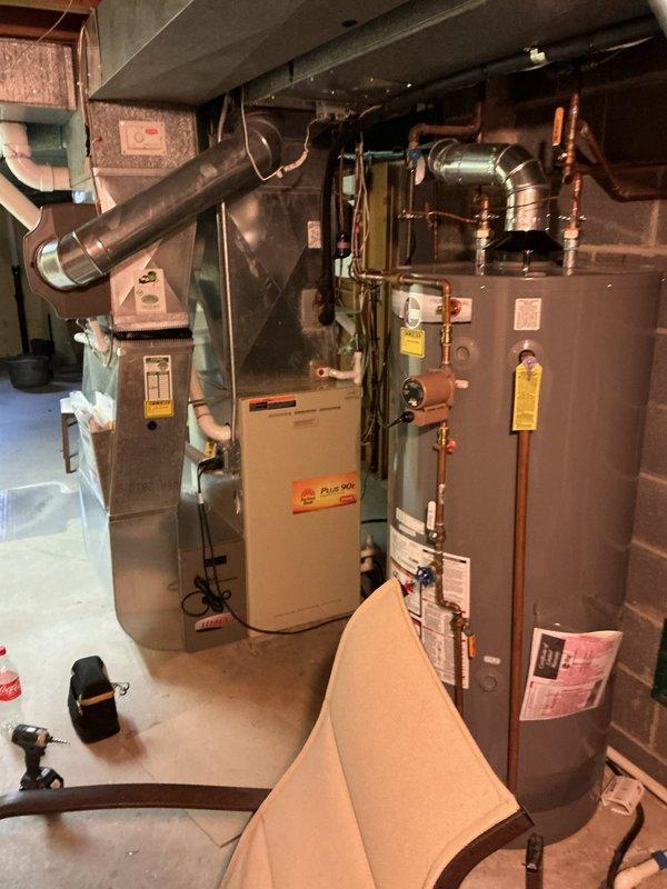 Completed comprehensive spring AC tune-up on residential cooling system. Performed standard maintenance protocol including inspection of condenser unit, refrigerant level verification, electrical connection testing, and air filter replacement. Inspected brand new bedroom air purifier unit reported as non-operational; identified power supply issue and restored unit to proper working condition. All HVAC equipment including furnace and water heater systems photographed and documented as functioning within normal parameters.