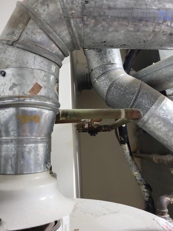 Completed comprehensive assessment of 10+ year old natural gas furnace and air conditioning system located in basement for replacement estimate. Both units currently operational but customer seeking replacement due to inefficiency concerns. Evaluated existing beige furnace unit with aged ductwork, associated gas lines, and AC system including overhead duct configuration and refrigerant lines. Documented equipment condition showing visible wear, surface discoloration, and dust accumulation throughout mechanical components. Provided detailed estimates for complete furnace and AC replacement system under quotes 07678-01 and 07678-03.