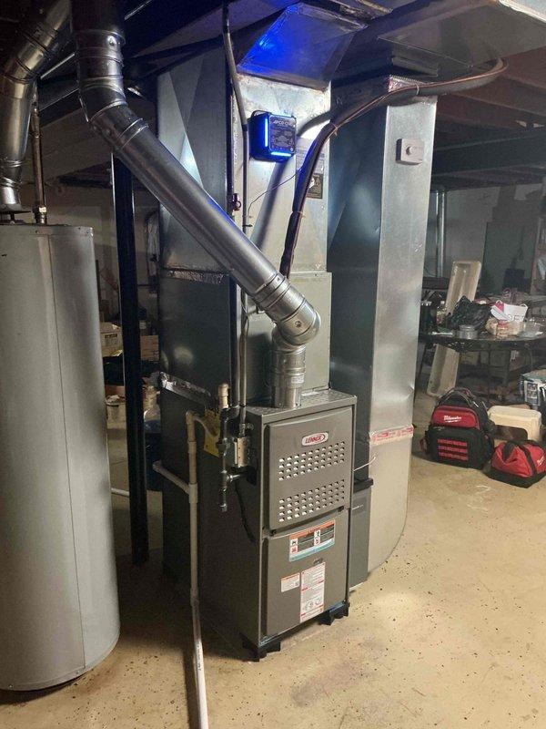 Completed installation of 70,000 BTU Lennox residential furnace in basement mechanical room with all required mechanical and electrical permits. Installed APCO UV air purification system in supply ductwork with blue indicator light, connected humidifier to system, and verified proper thermostat operation. Established dedicated electrical circuit at breaker panel, reconnected all ductwork including flexible and rigid metallic sections, and performed final system checkout to ensure proper furnace operation and airflow throughout the home.