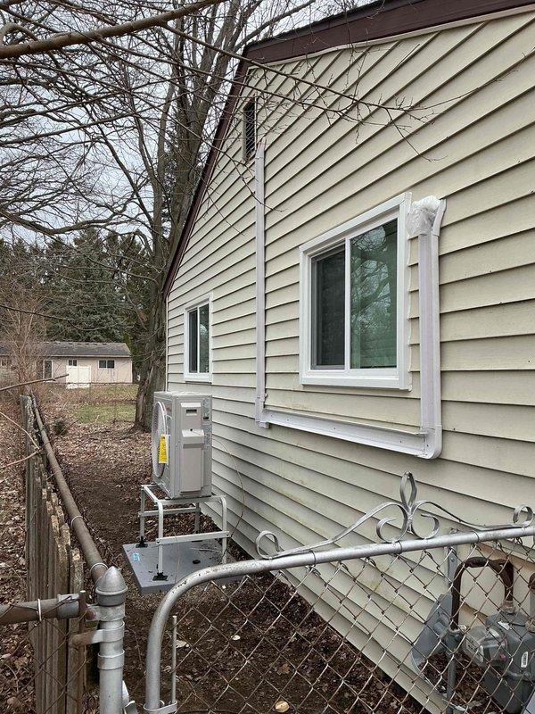 Completed two-day mini-split system installation at residential property, including mechanical and electrical work with new dedicated circuit. Outdoor condenser unit mounted on exterior wall bracket with proper refrigerant line installation and electrical conduit routing. Permit applications submitted for mechanical, electrical, and mini-split components prior to installation.