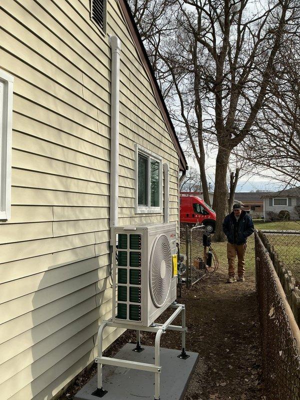 Completed two-day mini-split system installation at residential property, including mechanical and electrical work with new dedicated circuit. Outdoor condenser unit mounted on exterior wall bracket with proper refrigerant line installation and electrical conduit routing. Permit applications submitted for mechanical, electrical, and mini-split components prior to installation.