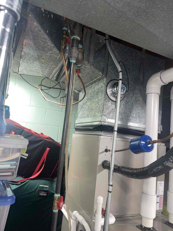 Completed comprehensive HVAC estimate for replacement of two aging air conditioning systems, both approximately 22 years old. Systems were found to be low on R410A refrigerant, indicating potential leaks or loss of system integrity common in units of this age. Assessed indoor air handler and furnace equipment in basement mechanical room, along with outdoor condensing units located on exterior patio. Documented existing infrastructure including copper refrigerant lines, condensate drainage systems, ductwork connections, and electrical service. Photographed current equipment configuration and mechanical room layout to support replacement proposal. Provided equipment recommendations and replacement options for dual-system installation to restore efficient cooling capacity and improve energy performance.