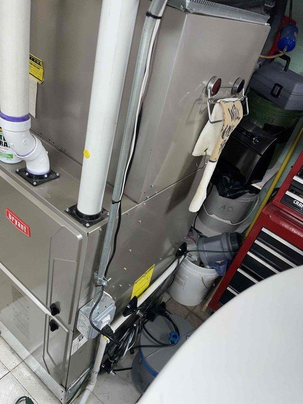 Completed comprehensive HVAC estimate for replacement of two aging air conditioning systems, both approximately 22 years old. Systems were found to be low on R410A refrigerant, indicating potential leaks or loss of system integrity common in units of this age. Assessed indoor air handler and furnace equipment in basement mechanical room, along with outdoor condensing units located on exterior patio. Documented existing infrastructure including copper refrigerant lines, condensate drainage systems, ductwork connections, and electrical service. Photographed current equipment configuration and mechanical room layout to support replacement proposal. Provided equipment recommendations and replacement options for dual-system installation to restore efficient cooling capacity and improve energy performance.