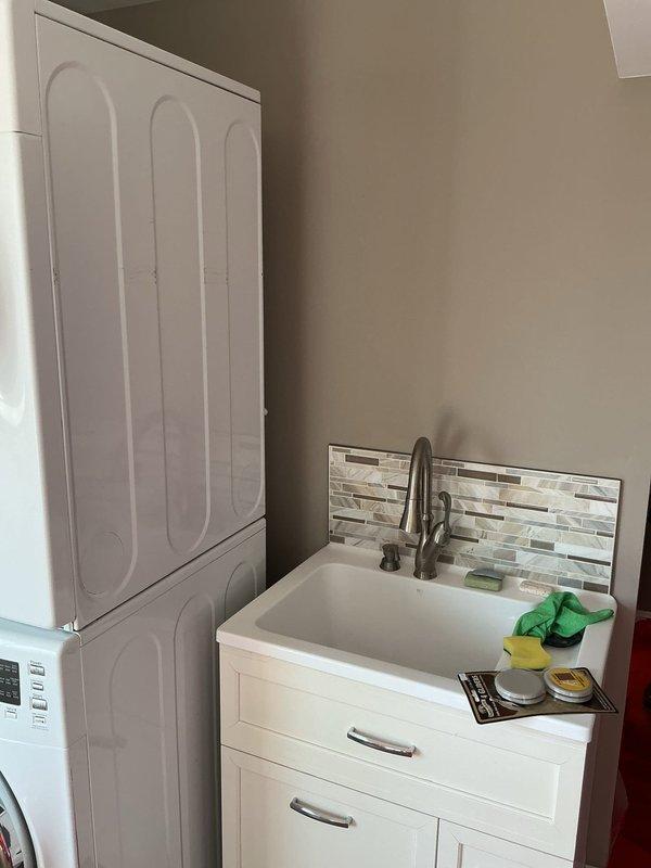 Completed code violation repairs for laundry room and lavatory venting system to bring installation into compliance with current plumbing codes. Installed new electrical junction box for light fixture, properly secured to structural stud framing to meet electrical code requirements. Addressed existing non-compliant electrical box that was inadequately mounted and featured an open cut in the wall surface. All work performed to pass inspection standards.