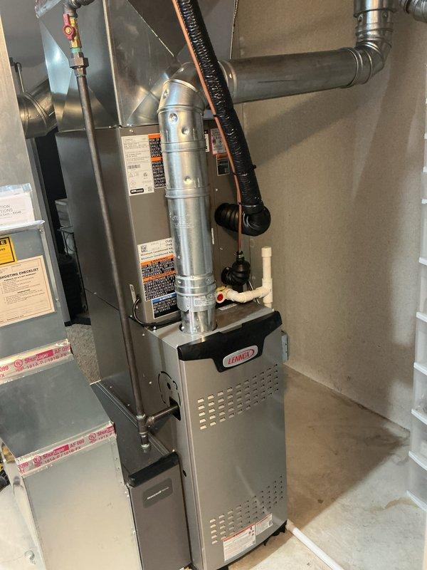 Completed full HVAC system installation including a Lennox 70,000 BTU furnace and 2.5-ton air conditioning unit with rear discharge configuration. Installed new 500-series humidifier and reconnected existing ductwork to new equipment. Performed refrigerant line flush and added new electrical wiring to code. Positioned outdoor condenser unit on composite pad with proper electrical disconnect box and conduit installation. Mounted furnace in basement utility area with proper plenum connections, PVC venting, and copper refrigerant lines with insulation. Requested and obtained mechanical and electrical permits for the installation. System qualifies for utility rebate program with AHRI certification number 21558662.