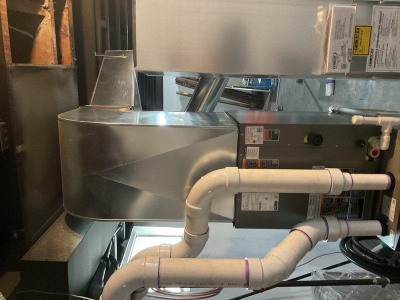 Completed full HVAC system installation including 70,000 BTU furnace, 2.5 ton air conditioning unit, ductwork alterations, and two-zone system with dual Ecobee 3 Lite thermostats. Installed new air handler with proper condensate drainage system using PVC piping, connected refrigerant lines, and configured zoning controls for independent temperature management. Modified existing ductwork to accommodate standard sizing where possible, secured mechanical permit, and verified system operation with AHRI certification matching requirements for utility rebate eligibility.