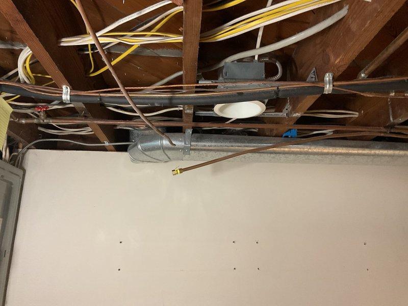 Conducted plumbing estimate for replacement of old capped copper gas line serving dryer location in basement of century-old single-family residence. Assessment included evaluation of existing gas piping from spring shutoff valve to dryer termination point, documentation of current system condition, and determination of scope for complete line replacement to restore safe gas supply to appliance.