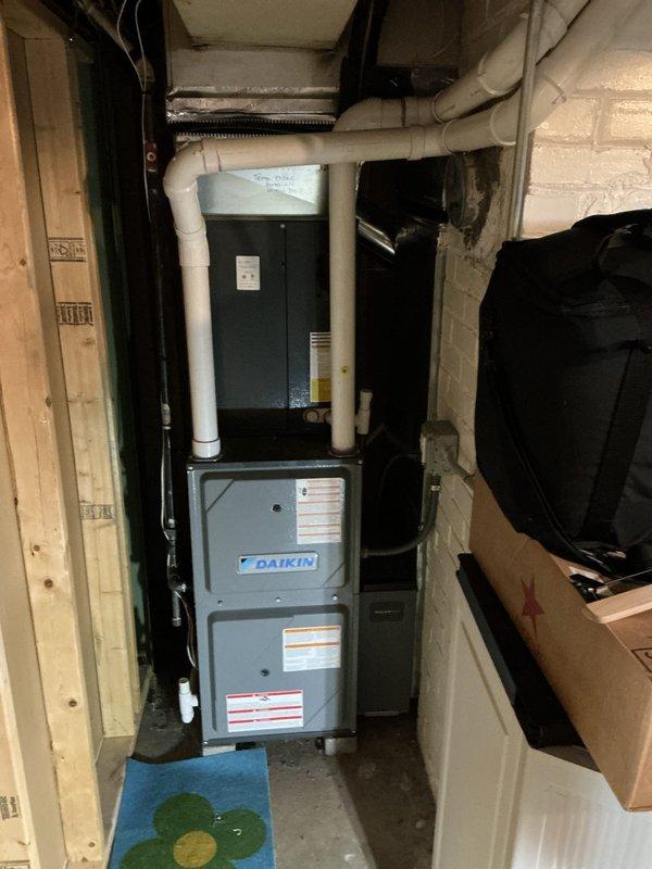 Completed NSP furnace inspection on Daikin unit located in basement utility area. Confirmed inducer motor has been ordered and is available for pickup at Williams Distributing under PO 1303127-001. Unit is accessible without ladder requirement, and all system components, ductwork, and PVC venting were visually inspected and documented with photographs.