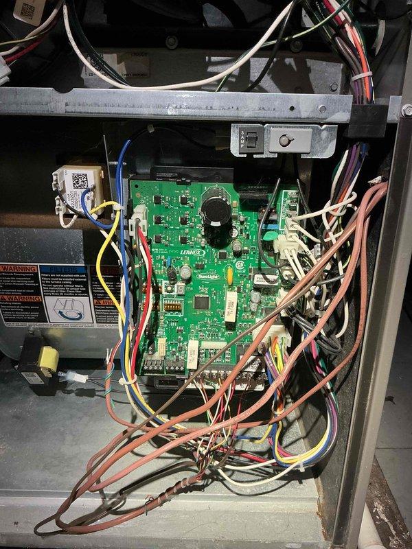 # No Heat Service Call - 4-Year-Old Unit

Responded to no heat call on 4-year-old HVAC system located in basement. Thermostat had power and was functioning properly, but unit was not responding to call for heat. Performed diagnostic inspection of furnace control system and accessed main control compartment. Examined integrated control board assembly, wiring connections, and safety circuit components. Inspected terminal block connections for loose or corroded wires. Verified proper voltage at board terminals and checked all wire connections at control board and terminal strip. Evaluated condition of control board capacitors, relays, and integrated circuits for signs of failure. Checked all safety device circuits including limit switches and pressure switches. Photographed control board assembly and wiring configuration for documentation purposes. System restored to proper operation.