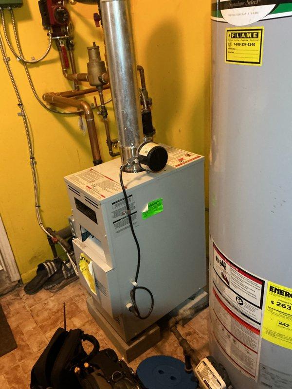 Completed preventive maintenance tune-up on a 2018 hot water boiler system located at the rear of the residence. Performed comprehensive inspection of the boiler unit, verified proper operation of circulator pump, examined all copper piping connections and shut-off valves for leaks, and confirmed exhaust venting system integrity. Tested and verified Emerson programmable thermostat functionality with system responding correctly to temperature setpoint commands at 77.1 degrees. All equipment found to be in operational condition with no immediate repairs required.
