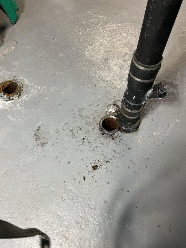 Responded to callback regarding floor drain backup and water accumulation in basement following previous floor break repair performed on 3/3. Conducted camera inspection of main drain system to assess drainage conditions and verify integrity of prior repair work. Inspection revealed standing water in drain line and backup at floor drain location. Documented interior basement conditions showing water pooling around floor drain opening with visible corrosion at drain rim and moisture present on surrounding floor surface. Black drain pipe connections and fittings were inspected for proper installation and potential failure points. Exterior inspection conducted to assess yard grade and potential surface water infiltration issues that may be contributing to basement drainage problems.