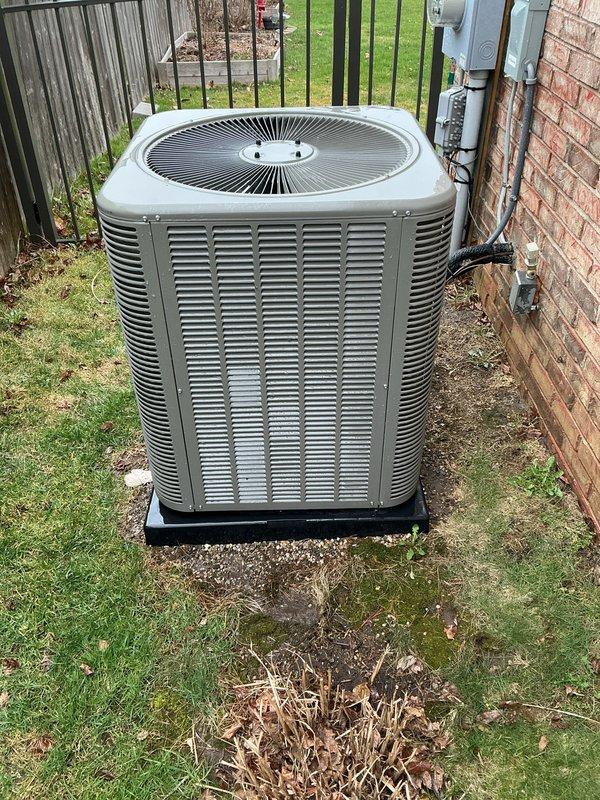 Completed comprehensive Gold AC Inspection and tune-up on a 2-year-old residential air conditioning system located on the north side of the property. Unit is positioned on a concrete pad against brick exterior wall with proper electrical disconnect and metering in place. Performed full preventive maintenance protocol including inspection of condensing unit, fan assembly, and all electrical connections. Verified proper operation of circular fan assembly with radial metal fins, checked refrigerant levels, cleaned condenser coils, and inspected louvered vents for adequate airflow. Examined electrical components including disconnect box and conduit connections mounted on building exterior. Unit operating within normal parameters with no deficiencies noted. System is in good condition for its age with proper installation on elevated pad for drainage. Membership renewal processed to include this maintenance visit.