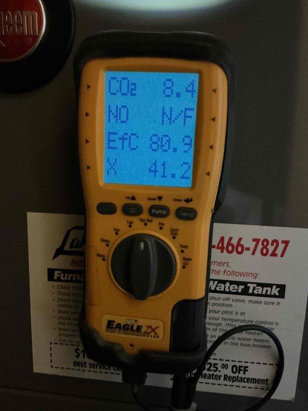 Completed comprehensive tune-up and safety inspection on basement-located furnace, hot water tank, humidifier, and thermostat system. Performed combustion analysis using digital analyzer, recording CO2 levels at 8.4%, oxygen at 20.9%, with zero carbon monoxide detected and stack temperature at 98.9°F. All equipment found operating within normal parameters with no deficiencies noted.
