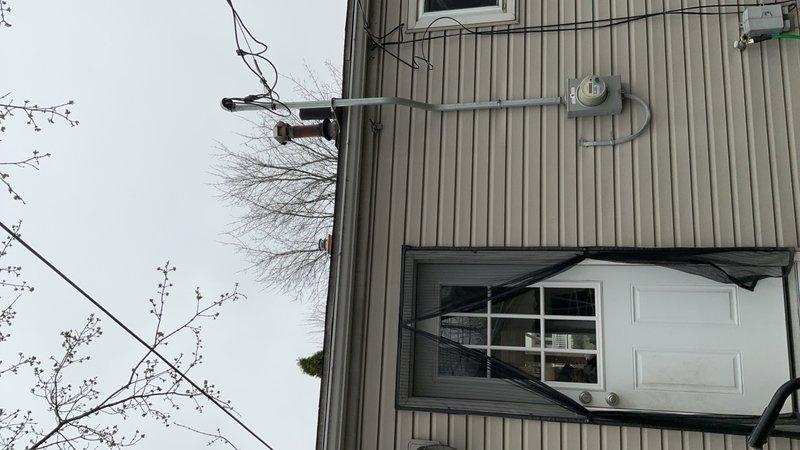 Completed installation of 40-gallon gas water heater at residential property. Installed new unit with proper venting through exterior wall, including red vent pipe with protective cap visible on building exterior. Connected gas supply line with required drip leg for condensation management and safety compliance. Verified all connections for proper operation and tested system functionality. Ensured venting meets code requirements for safe exhaust of combustion gases to building exterior.