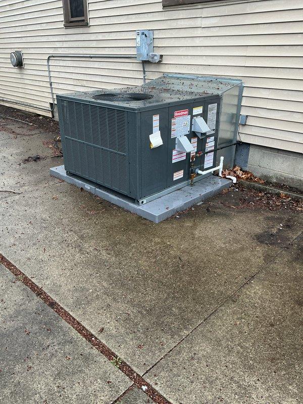 Performed system start-up on Goodman packaged heating and cooling combo unit installed on concrete pad adjacent to residential structure. Verified proper operation of all components, checked refrigerant line connections at building penetration, and confirmed electrical connections at exterior meter location. Unit operational and performing to manufacturer specifications.