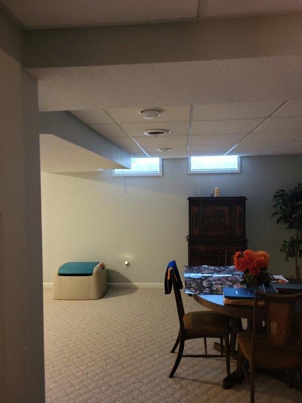 Provided comprehensive estimate for replacement of 38-year-old air conditioning system currently located in basement alongside existing natural gas furnace and associated ductwork. Assessed current equipment configuration, including metal air handler unit with silver metallic finish, existing PVC condensate drainage system with pump, and evaluated basement space conditions for new equipment installation. Documented equipment specifications and site conditions to develop replacement options for aging but currently operational AC system.