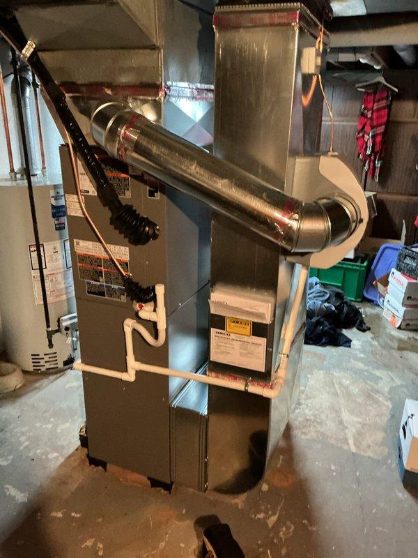 Performed AC system startup and commissioning on newly installed basement evaporator coil and furnace system. Verified proper refrigerant charge, airflow through metal plenum and ductwork, and confirmed all electrical connections to the furnace unit. Tested system operation including blower motor function, verified intake and exhaust venting through white PVC pipes, and ensured proper condensate drainage. System startup completed successfully with all components operating within manufacturer specifications.