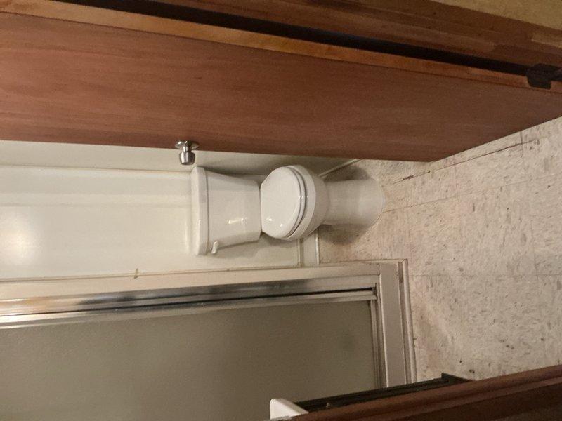 Completed toilet installation in residential bathroom per customer request with morning arrival window. Removed existing toilet fixture and installed new white porcelain toilet with standard oval seat design, ensuring proper sealing and secure mounting to floor flange. Verified proper water supply connection, tested flush mechanism for adequate water flow and drainage, and confirmed no leaks at base or supply line connections. Materials were sourced from Madison Heights plumbing supply under designated purchase order. Installation completed on existing wood-grain laminate flooring with all fixtures operating correctly upon completion.