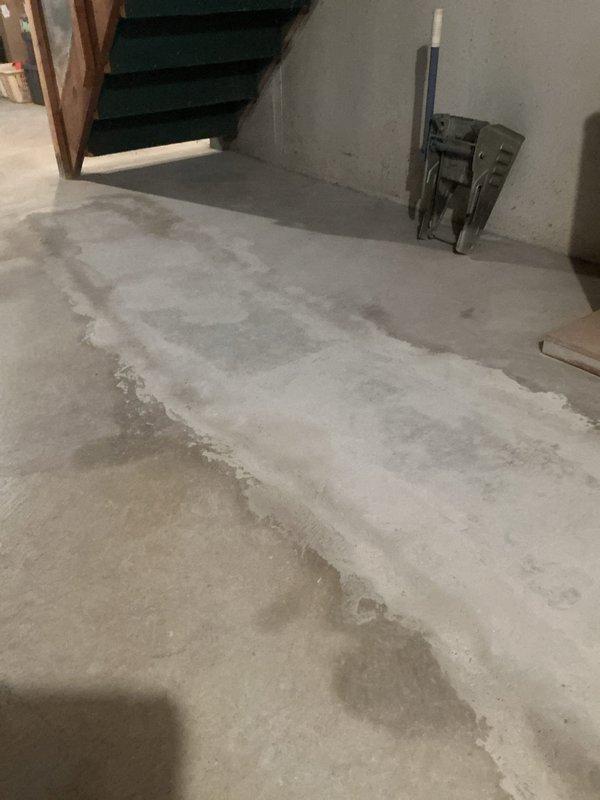 Responded to callback for basement plumbing installation inspection. Documented newly installed white PVC drainage and vent piping system running vertically through unfinished basement space during active renovation phase. Verified proper pipe placement and securing methods through plastic vapor barrier and wall framing, confirmed system integration with existing infrastructure, and photographed concrete floor conditions showing recent pouring work with visible seam lines for customer records.