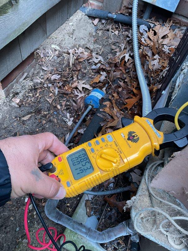 Completed comprehensive Gold AC inspection on multi-unit residential HVAC system with two air conditioning units manufactured in 1991 and 2001. Performed electrical diagnostics and measurements on both outdoor condensing units using digital multimeter to verify proper voltage, amperage, and system performance. Inspected condenser units exterior components, cleared surrounding area of leaves and debris accumulation, and tested operational parameters. Accessed attic-mounted air handler and evaporator coil for visual inspection and performance verification. Both systems confirmed operational and functioning within acceptable parameters at time of inspection.