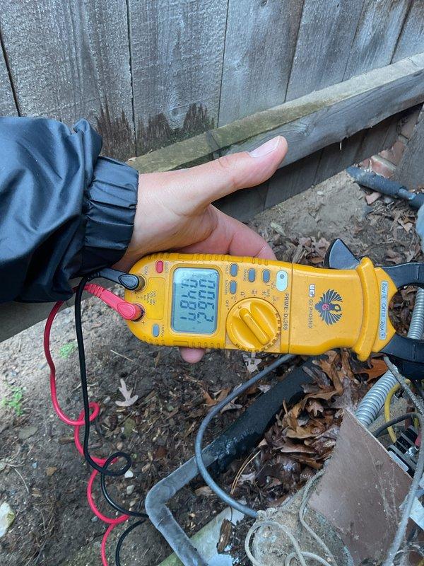 Completed comprehensive Gold AC inspection on multi-unit residential HVAC system with two air conditioning units manufactured in 1991 and 2001. Performed electrical diagnostics and measurements on both outdoor condensing units using digital multimeter to verify proper voltage, amperage, and system performance. Inspected condenser units exterior components, cleared surrounding area of leaves and debris accumulation, and tested operational parameters. Accessed attic-mounted air handler and evaporator coil for visual inspection and performance verification. Both systems confirmed operational and functioning within acceptable parameters at time of inspection.