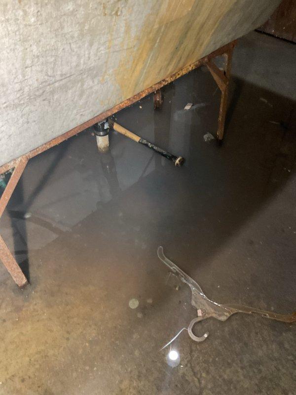 Responded to basement drain backup occurring in specific area following laundry use. Upon arrival, found standing water covering basement floor with visible moisture damage on walls indicating active flooding condition. Performed main drain cleanout service by accessing floor drain openings and utilizing mechanical augering equipment to clear blockage in main sewer line. Successfully removed obstruction and restored proper drainage flow, eliminating backup issue. Tested system to verify complete clearance and proper function of drainage system.