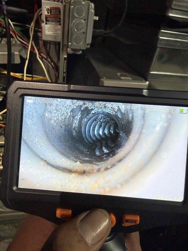 Responded to no-heat call on 14-year-old furnace displaying thermostat error code. Performed diagnostic inspection using borescope camera to examine heat exchanger and internal components for cracks, corrosion, and blockages. Inspected blower wheel assembly and found moderate dust accumulation on blades affecting airflow efficiency. Cleaned blower wheel, verified proper operation of all mechanical and electrical components, cleared error code, and restored heating system to normal operation.