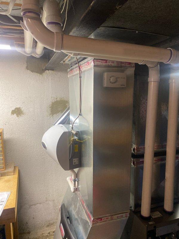 Completed full furnace replacement installing a new 70,000 BTU unit in basement utility room. Installation included humidifier integration, flue liner replacement, and reconnection of all ductwork and electrical systems. Permit was requested and consumers energy rebate documentation submitted for $300 qualification.