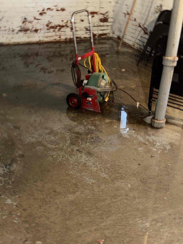 Responded to service call for 14-year-old furnace unit in basement that would not turn on properly, with suspected blower motor failure and ignition issues. Upon arrival, discovered significant water damage throughout basement with extensive flooding on concrete floor, which had compromised the furnace system's electrical components and prevented proper operation. Deployed water extraction equipment including pump and hoses to begin removing standing water from the affected area. Due to the severity of the flooding and water damage to the furnace equipment, recommended immediate water remediation and full assessment of furnace components once area is dried, as moisture infiltration had likely damaged the blower motor, ignition system, and other electrical controls, making the unit unsafe to operate in current conditions.