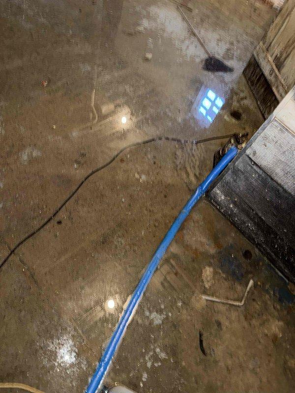 Responded to service call for 14-year-old furnace unit in basement that would not turn on properly, with suspected blower motor failure and ignition issues. Upon arrival, discovered significant water damage throughout basement with extensive flooding on concrete floor, which had compromised the furnace system's electrical components and prevented proper operation. Deployed water extraction equipment including pump and hoses to begin removing standing water from the affected area. Due to the severity of the flooding and water damage to the furnace equipment, recommended immediate water remediation and full assessment of furnace components once area is dried, as moisture infiltration had likely damaged the blower motor, ignition system, and other electrical controls, making the unit unsafe to operate in current conditions.