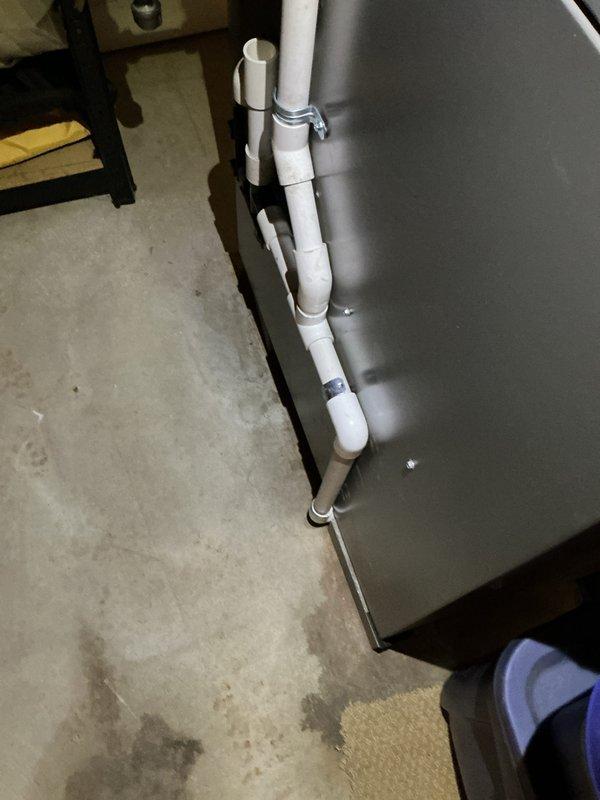 Completed air conditioning system startup on Lennox outdoor condenser unit. Performed comprehensive system commissioning including verification of refrigerant charge, electrical connections, and operational testing to ensure proper cooling performance. Documented installation with photographs showing exterior condenser placement on composite pad and interior condensate drain piping configuration connected to water heater system.