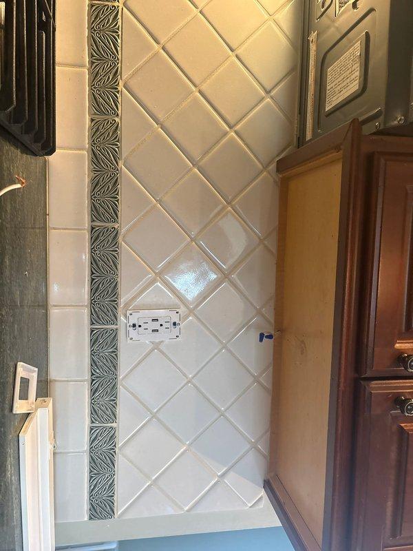 Responded to service call for non-functional under-cabinet and range hood lighting in kitchen area. Performed diagnostic assessment of electrical circuit serving decorative tile backsplash area with existing outlet installation. Troubleshot wiring connections at junction box location near ceiling where cabinet lighting fixtures tie in. Identified and resolved electrical connectivity issue affecting lighting operation. Verified proper function of cabinet lighting system and confirmed all electrical connections secure and code-compliant upon completion.