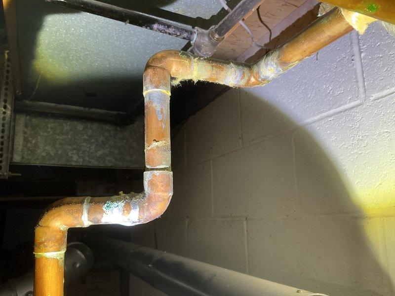 Replaced hot side copper riser that was previously omitted during water heater installation. Installed new copper piping with proper 90-degree elbow fittings along vertical run in basement utility area. Completed installation according to estimate specifications, ensuring proper connections and system integrity for residential hot water distribution system.