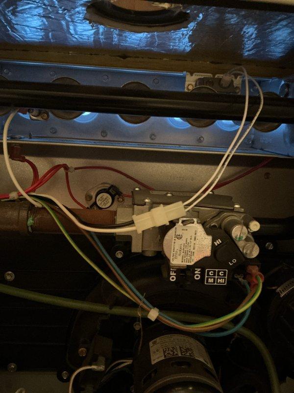 Completed comprehensive NSP furnace and air conditioning system inspection on residential property with multiple HVAC units over 10 years old. Performed thorough examination of basement-located furnace, inspecting internal components including control module, wiring connections, and mechanical assembly. Verified proper operation of control board with all wire connections intact, including red, white, green, and blue control wiring. Assessed exterior air conditioning condenser unit, examining fan motor operation, condenser coil condition, and electrical connections. Noted outdoor unit showing normal age-related wear with accumulated debris around base. Cleared leaves and organic material from perimeter of condenser to ensure proper airflow. Confirmed both heating and cooling systems operational with no immediate safety concerns identified.