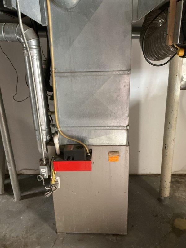 Provided estimate for complete furnace replacement following previous shutdown due to critical safety issues including seized inducer motor, failed blower motor with significant oil leakage, and cracked heat exchanger. The 10+ year old natural gas furnace located in basement was deemed non-operational and unsafe for continued use. Assessed existing ductwork configuration and utility connections to determine replacement specifications for new equipment installation.