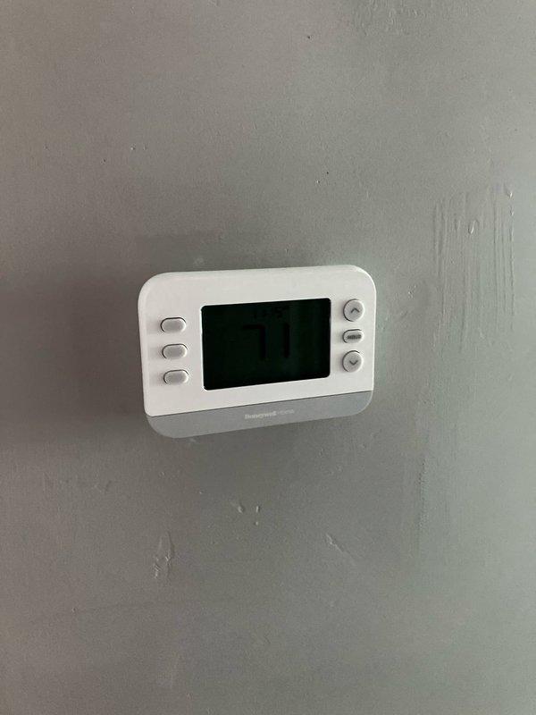 Conducted on-site assessment of non-operational natural gas furnace located in basement. Evaluated existing 10+ year old heating system showing significant age-related deterioration, dust accumulation, and general wear. Documented current equipment configuration including furnace unit, thermostat, and ductwork to provide comprehensive replacement estimate for new gas-fired heating system.