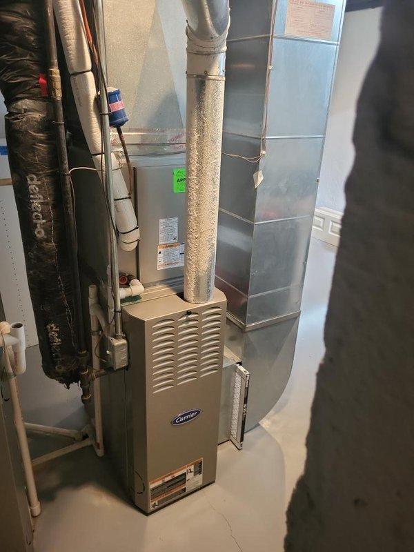 Provided comprehensive estimate for replacement of two natural gas furnaces and one air conditioning system in basement installation. Existing equipment operational but over 10 years old and approaching end of service life. Evaluated current Carrier furnace setup with associated ductwork, air handler, and refrigerant lines, along with two outdoor condenser units mounted on exterior brick wall. Assessment included review of gas supply configuration, electrical connections, duct distribution system, and condensate drainage requirements for complete system replacement recommendation.