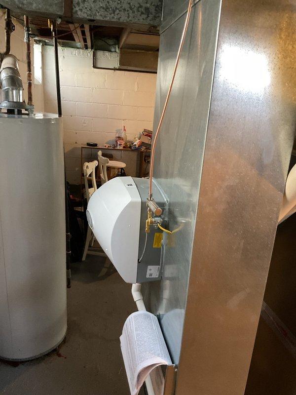 Installed Aprilaire 500A whole-home humidifier on existing Bryant HVAC system in basement mechanical room. Unit was mounted to supply ductwork with proper saddle valve connection to domestic water supply line and drainage tube routed to floor drain. System was tested and verified operational to improve indoor air quality during heating season.