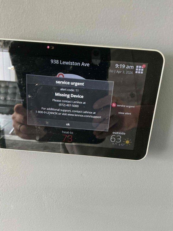 Responded to no-heat call on four-year-old Lennox furnace system with communication error between smart thermostat and heating unit. Diagnosed Alert Code 11 indicating missing device communication on Lennox iComfort thermostat. Inspected furnace control board and wiring connections in mechanical space, identified failed communication module with blue LED indicator light mounted on furnace platform. Replaced defective communication interface module, restored proper signal transmission between thermostat and furnace control system, and verified system operation with successful heat call.