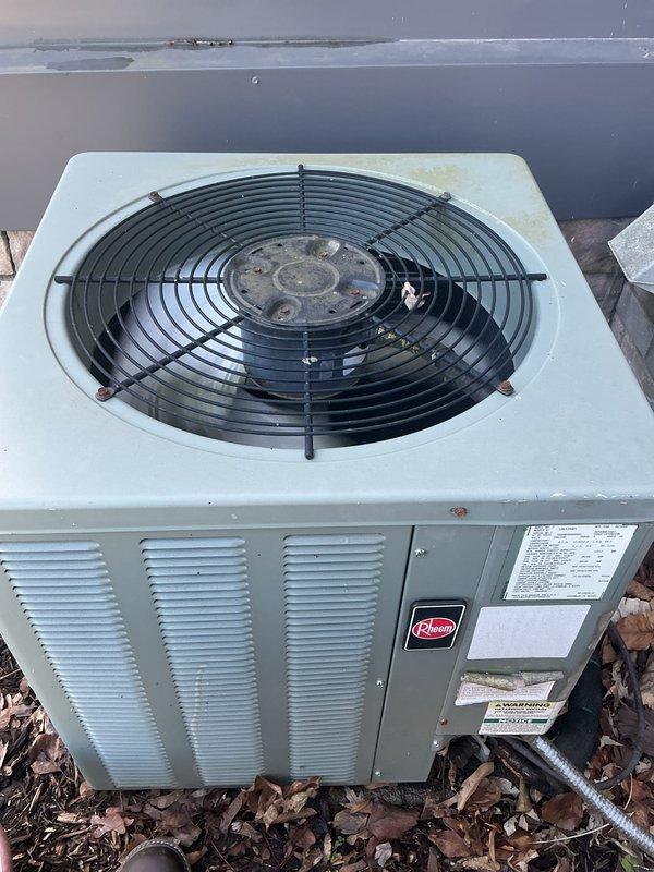 Completed comprehensive Gold AC inspection on residential split system with basement air handler configuration. Performed full system evaluation on Rheem condensing unit, including visual inspection of exterior housing, fan assembly operation, refrigerant line connections, and electrical components. Verified proper airflow through condenser coils, checked fan guard integrity, and confirmed unit is operating within normal parameters. Inspected installation pad condition and surrounding area for adequate clearance and drainage. System shows normal wear consistent with age, with unit maintaining proper function and no immediate service concerns identified. All components inspected and found to be in satisfactory working condition.